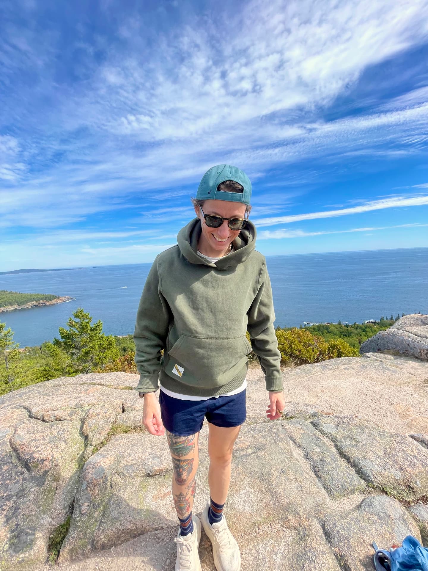 Emily Buckley on a rocky summit above the coast
